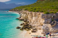 Sea kayakers on white sand beach of Isla Carmen, Sea of Cortez, Baja, Mexico.