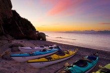 Sunrise with sea kayaks on beach on Isla Carmen, Baja, Mexico.