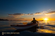 Sea kayaker paddling at sunrise, Sea of Cortez, Baja, Mexico.