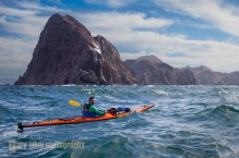 Sea kayaker in refracted waves off Punta Lobos, Isla Carmen, Baja, MX.