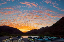 Sea kayaks on the shore at Puerto Balandra on Isla Carmen at a classic Baja sunrise.