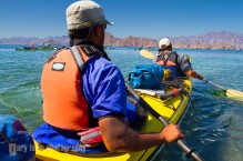 Sea kayak guides launch a double kayak from Punta Arena on Isla Carmen, Sea of Cortez, Baja, Mexico. (MR)