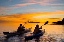 Sea kayakers paddle toward sunrise, Los Gatos, Sea of Cortez, Baja, Mexico.