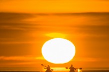 Sea kayakers paddle toward sunrise, Los Gatos, Sea of Cortez, Baja, Mexico.