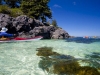 Kayaking glides over white shell beach near Balaclava Island, Queen Charlotte Strait, BC, Canada.