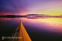 Kayak bow and sunrise on Skagit Bay, Washinton, USA.