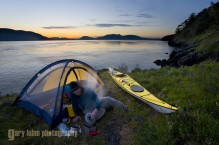 Man at kayak camp, Strawberry Island, San Juan Islands, Washington State, (MR).