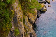Aerial view of sea kayaker in swirling tidal current at Deception Pass, Washington State. (MR).