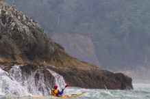 Sea kayaker Eugene Lavaque near Alexander Island, Olympic National Park, Washington State.