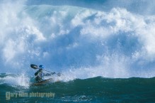 Jim Grossman defies a wave while kayak surfing in storm at Santa Cruz Kayak Surf Festival, Santa Cruz, CA. (MR).