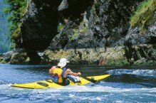 Sea kayaker Tim Walsh at entrance to Johnson Lagoon, Checleset Bay, Vancouver Island, British Columbia, Canada.