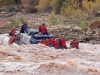 Cataract Canyon. Tag-A-Long Raft Guide Karen Sallon steers through a Colorado River rapids.
