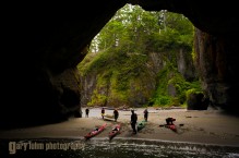 Sea kayakers explore sea caves and arches at Cape Flattery, Olympic Penninsula, Washington State.