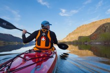 Male sea kayaker on Alkali Lake in eastern Washington state. (MR)
