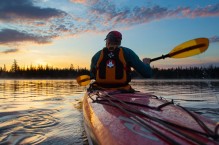 Sea kayaker on Big Lake at dawn, Oregon Cascades.