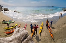 Sea kayakers on a desolate Olympic Coast beach near Cape Flattery. Digital composite.