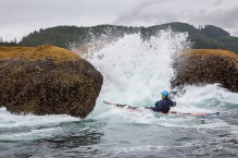 Sea kayaker Don Cheyette plays in rock garden in moderate swell, near Cape Flattery on the Olympic Coast.