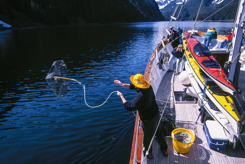 Throwing out shrimp pot from charter yacht Ursa Major at Red Bluff Bay, Baranof Is, AK.