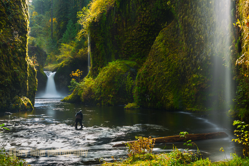 After crossing Eagle Creek, I backed up to include the water streaming in from the canyon walls. Backlighting and a polarizing filter enhance the scene, and a hat held out and above the lens prevented flare. The photographer in the image has donned hip waders, allowing him movement to just about anywhere in the basin. Punchbowl falls, Eagle Creek, Columbia River Gorge, Oregon. Canon 5D III, 24-105mm f/4L @55mm, f/16,   .4sec, iso50.